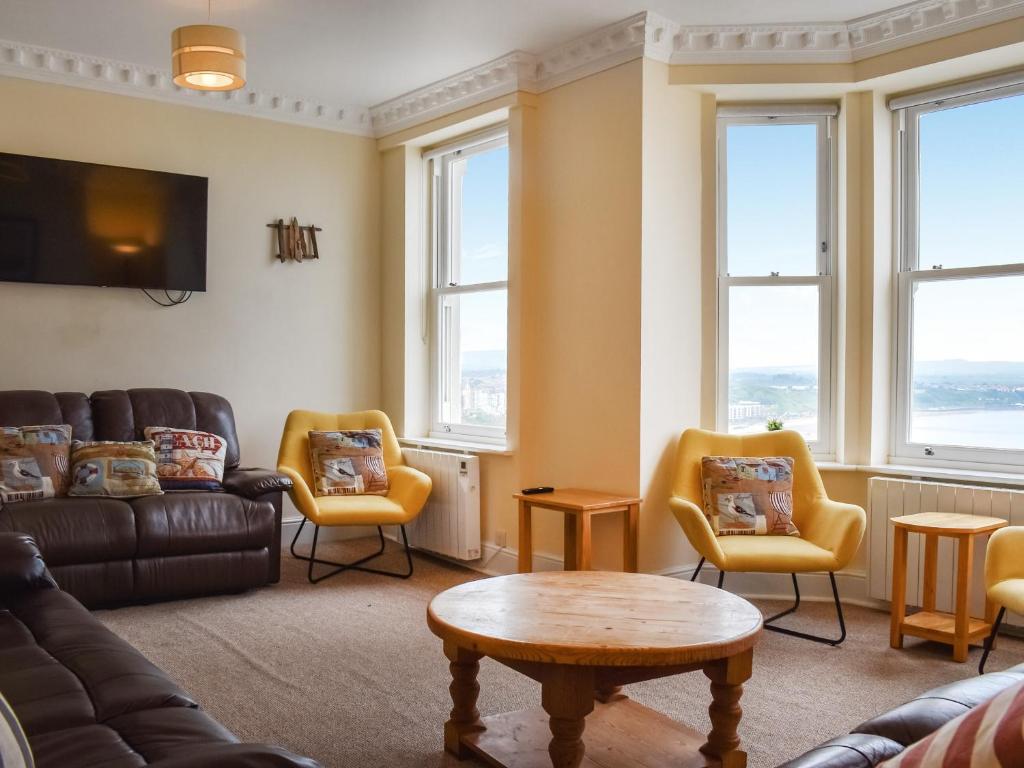 a living room with a couch and chairs and windows at Denelea - Uk49954 in Scarborough