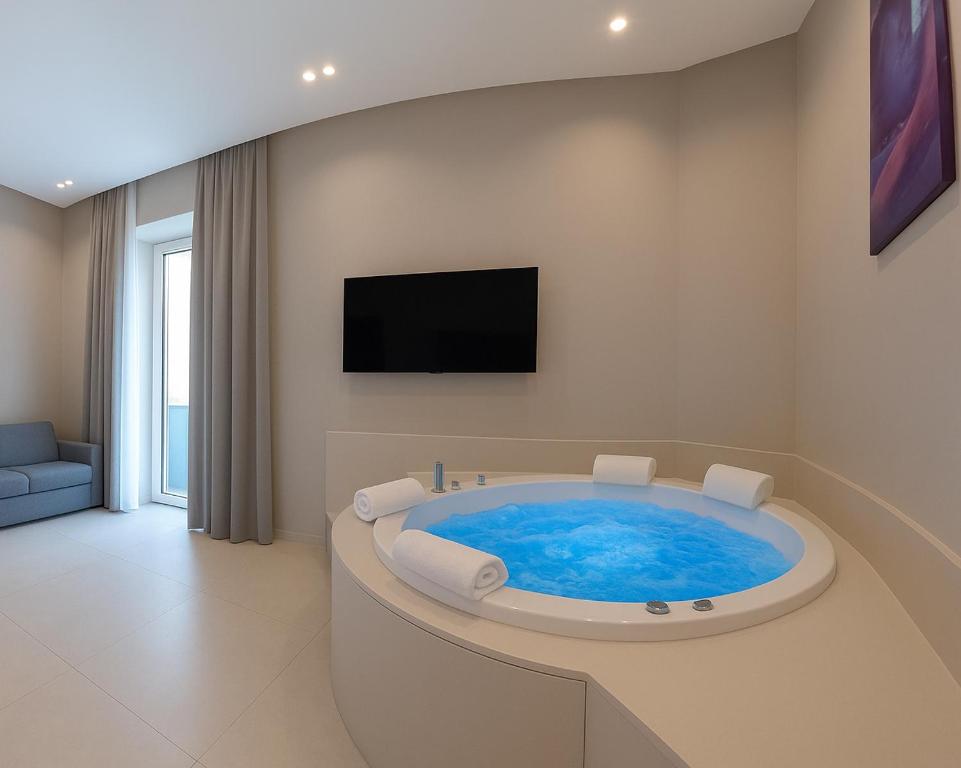 a bathroom with a jacuzzi tub with a tv at Dimora Angioina in Naples