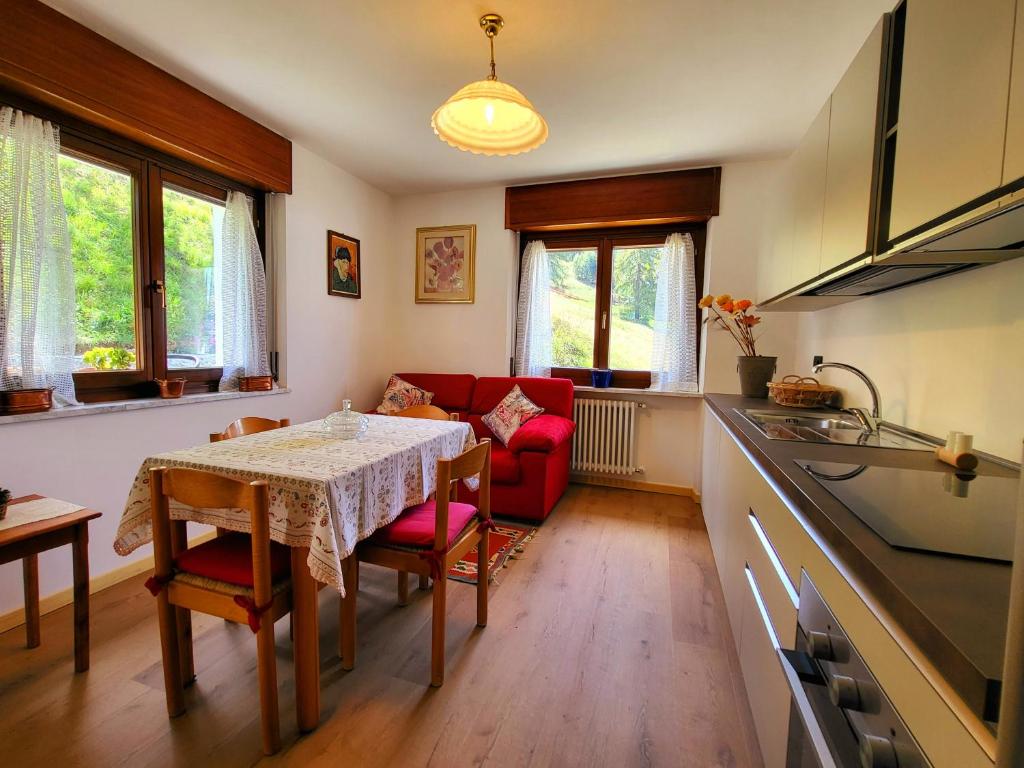 a kitchen with a table and a red couch at Molo 2 Pila in Gressan