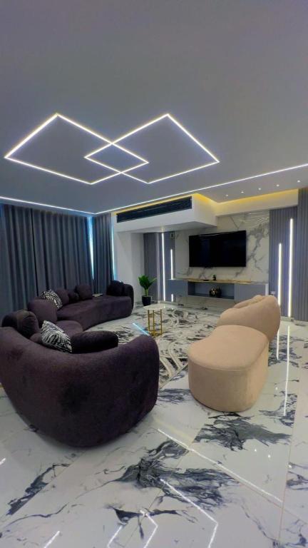 a large living room with couches and a tv at Alraja89 in Kafr Abū ʼumaydah
