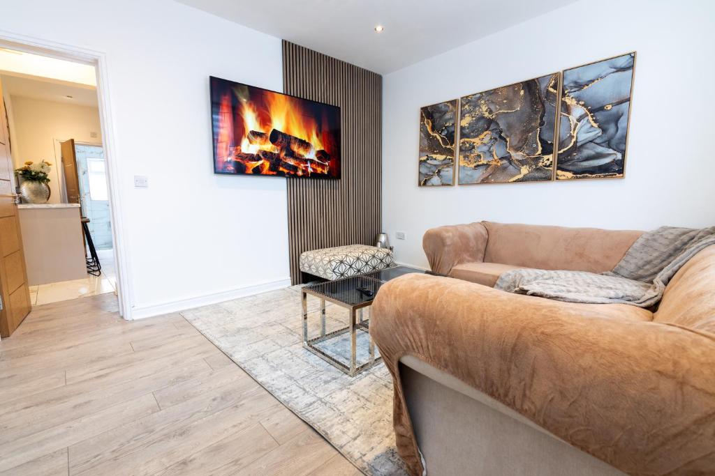 a living room with a couch and a fireplace at Perfect Booking Stylish 2 Bed Home In Stockport in Manchester