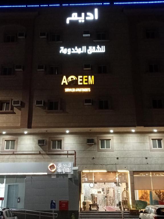 an apartment building with a sign on the side of it at Adeem Serviced Apartments in Buqayq