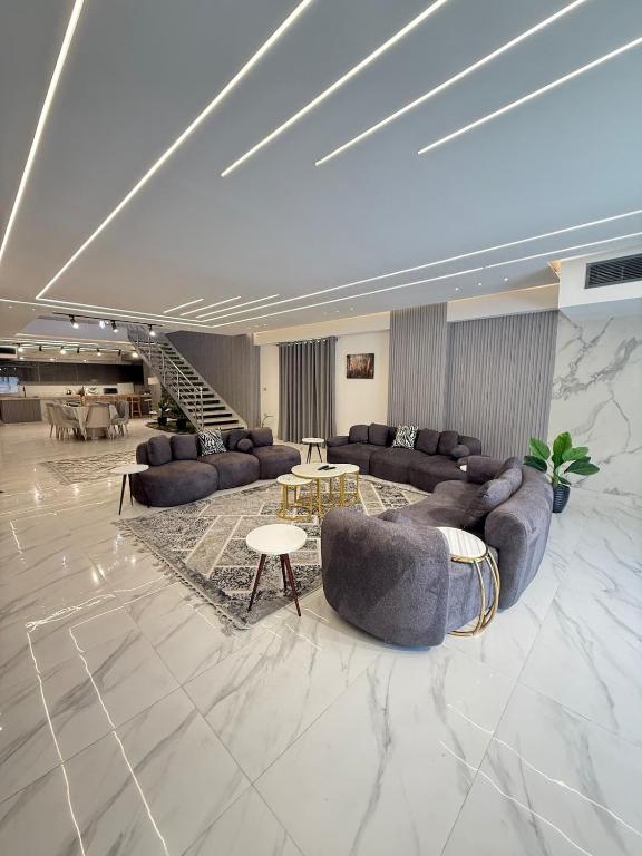 a large living room with couches and a table at Luxury villa 7 bedrooms elshick Zayed in Kafr Abū ʼumaydah
