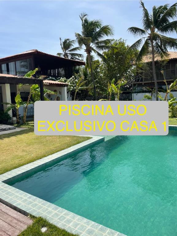 a swimming pool in front of a villa at Casas Oceanicas in Icaraí