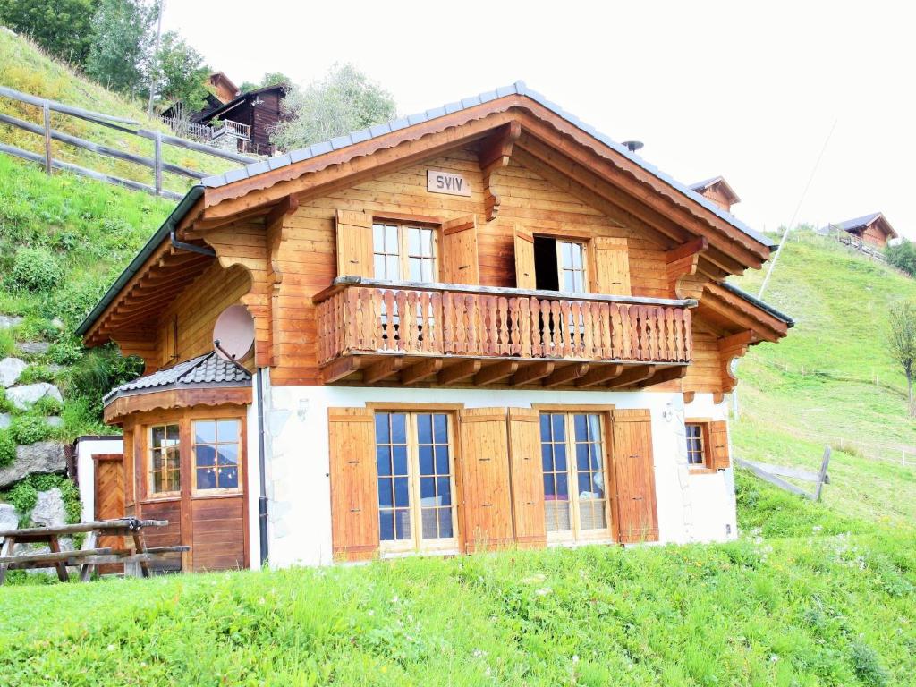 a house with a balcony on top of a hill at Chalet in Rhone Valley near Ski Lift in Les Collons