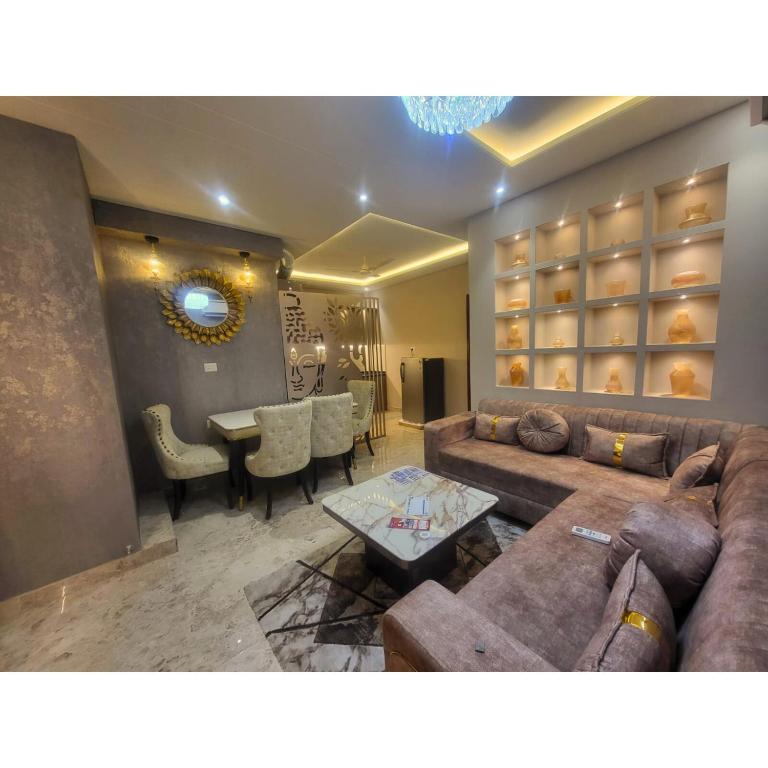 a living room with a couch and a table at Jaltara Stays in Jaipur