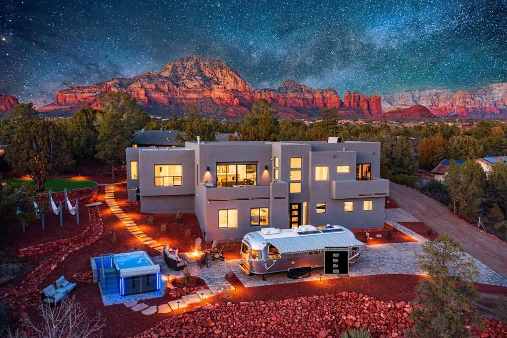 a large house with a truck parked in front of it at night at Sedona Epic Dream 5BR Pool & Spa Rooftop in Sedona