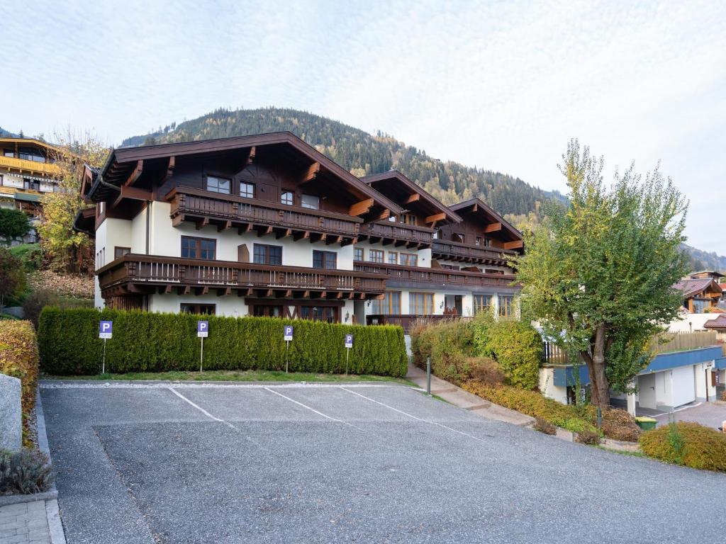 a large building with a tennis court in front of it at Alpine Apartment near Kaprun in Piesendorf