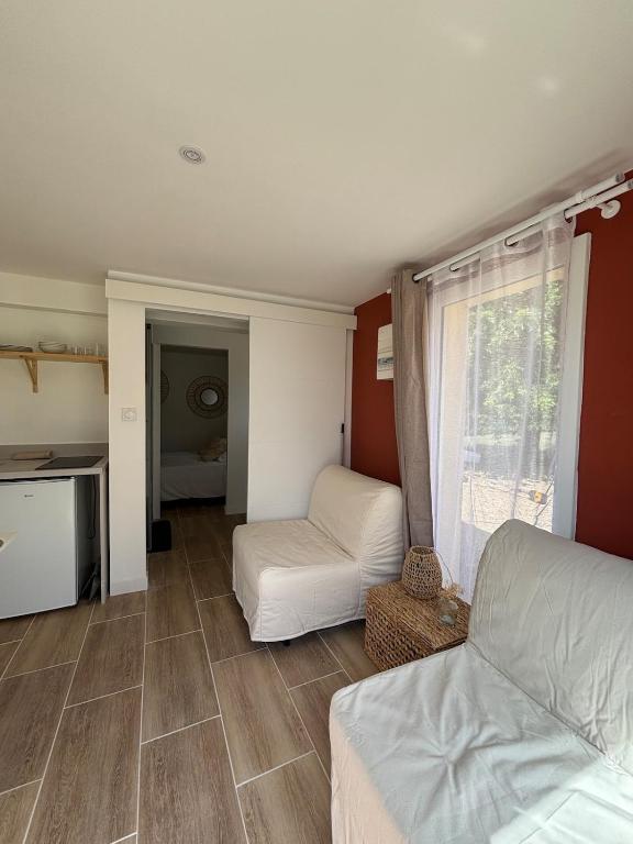 a living room with a bed and a couch at Maison in Lamonzie-Saint-Martin