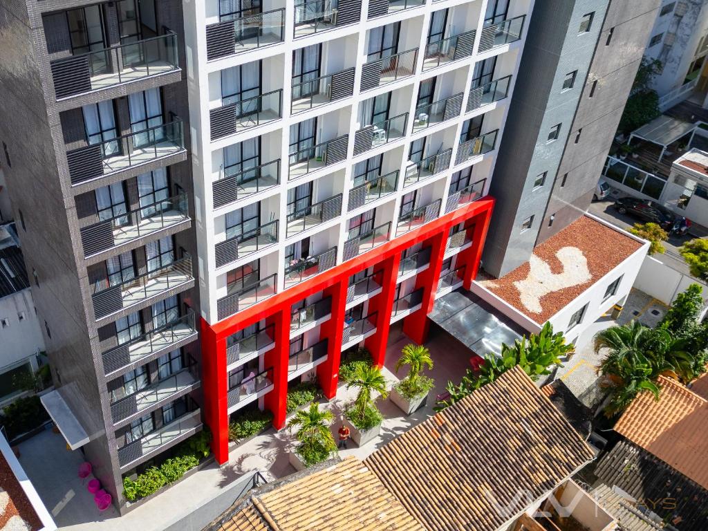 an overhead view of a tall apartment building with a red structure at Porto Privilege by VLV Stays in Salvador