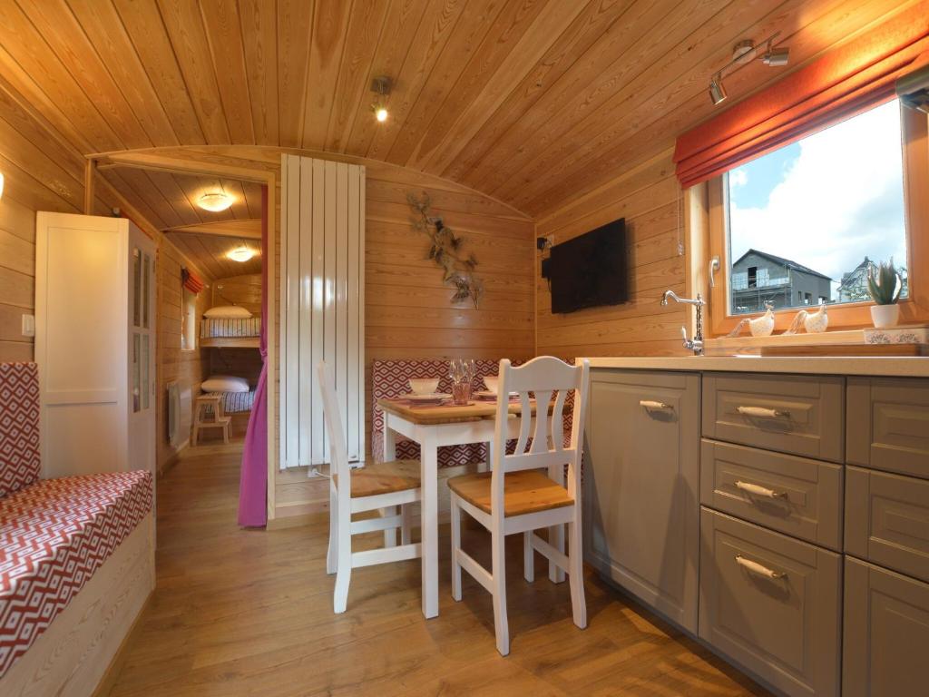 a small kitchen with a table and a sink in a room at Wellness Escape in Bellevaux in Malmedy