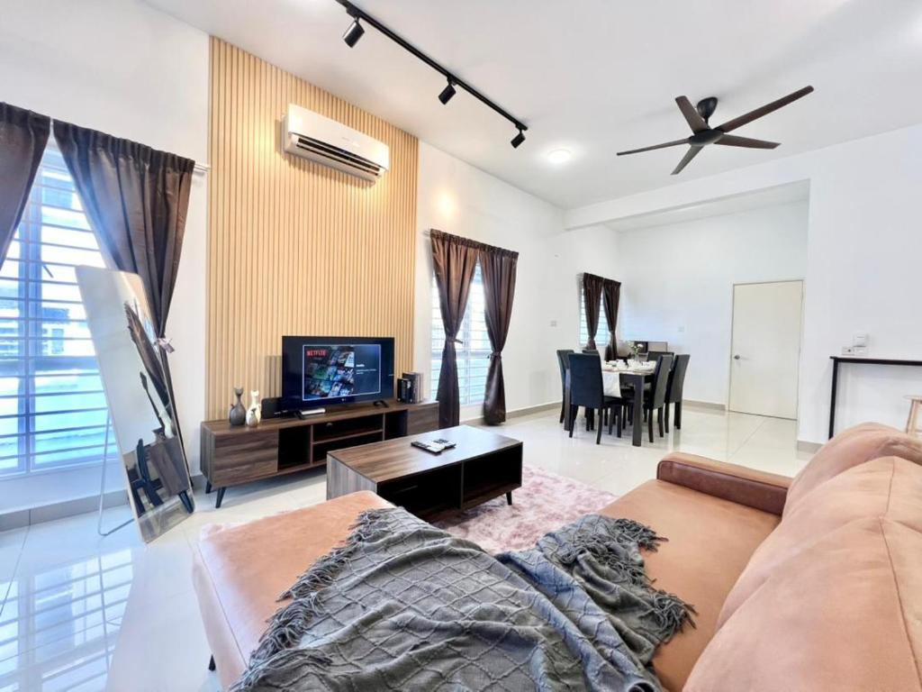 a living room with a couch and a tv at Semi D 16pax Landed Home WiFi Setia Alam Mall SCCC in Shah Alam