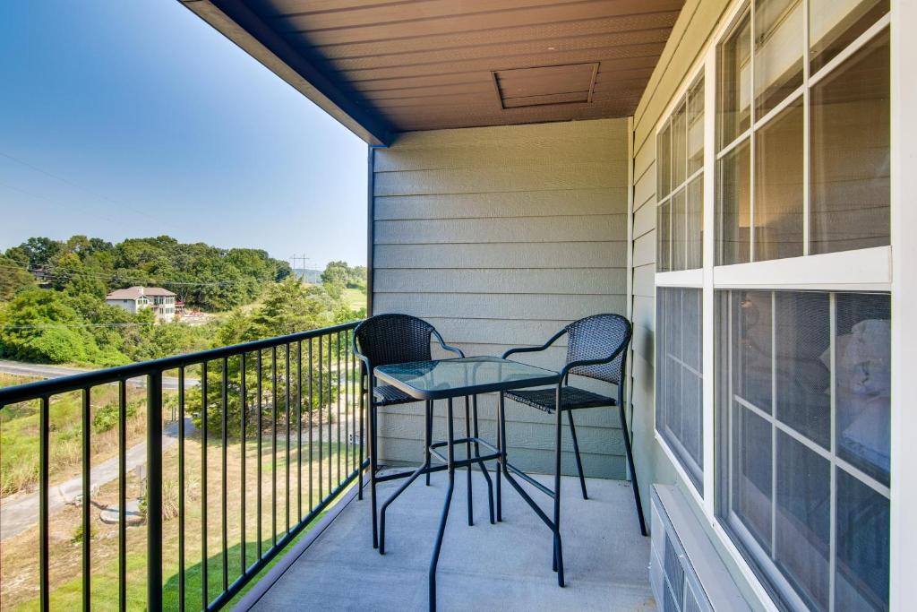 a balcony with two chairs and a table at Renovated Resort Condo, 2 Mi to Silver Dollar City in Reeds Spring