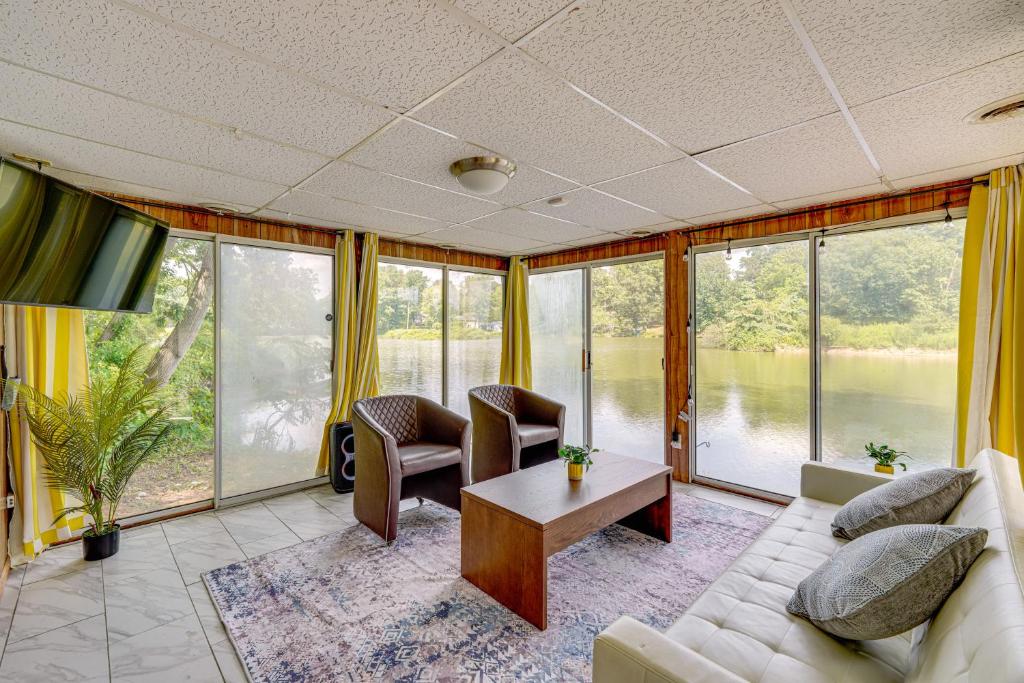 a living room with a couch and a table at Cozy House on Meadowbrook Lake Serene, Scenic! in Stow