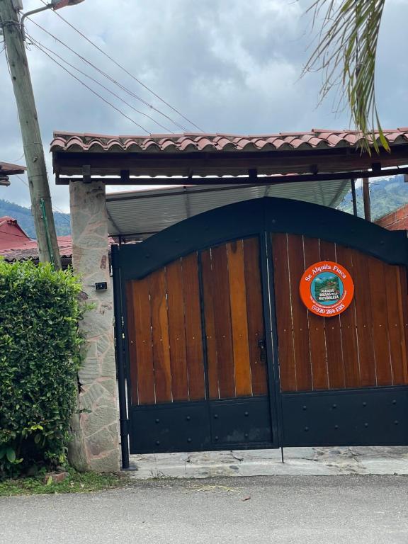 a wooden garage door with a sign on it at Paraiso brisas de la naturaleza in Tona