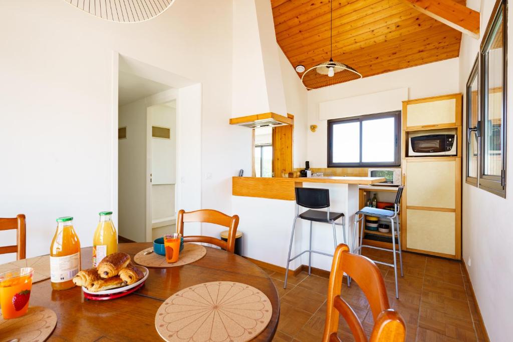 a kitchen and dining room with a table and chairs at Borda in Mouguerre