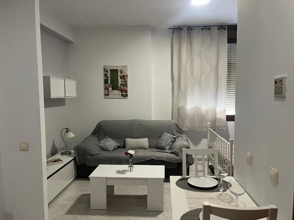 a living room with a couch and a table at Apartamento lux capilla in Seville