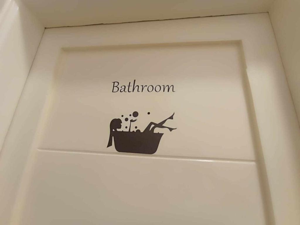a shelf with a bathroom sign on the wall at Oasis marina الاحياء in Hurghada