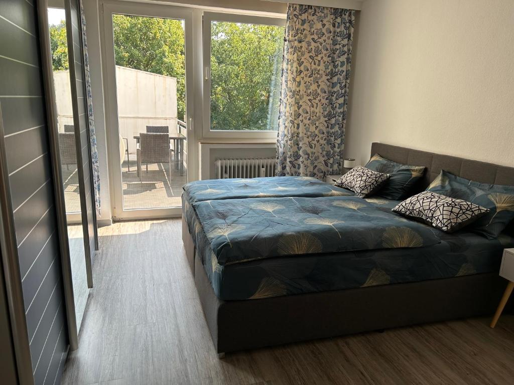 a bedroom with a bed and a large window at Stadtkern Apartment Bad Laasphe in Bad Laasphe