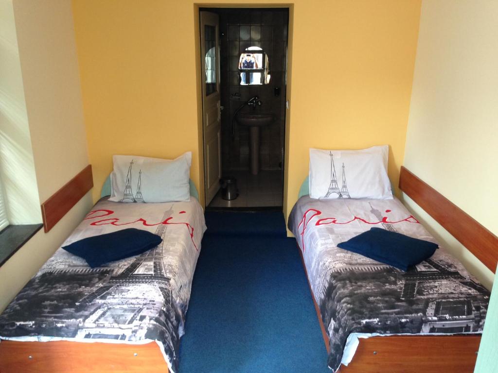 A bed or beds in a room at Hotel Bilyana