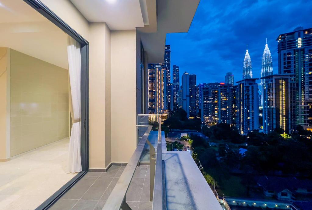 a balcony with a view of the city at night at TM Persiaran Stonor KLCC - MK HOME in Kuala Lumpur