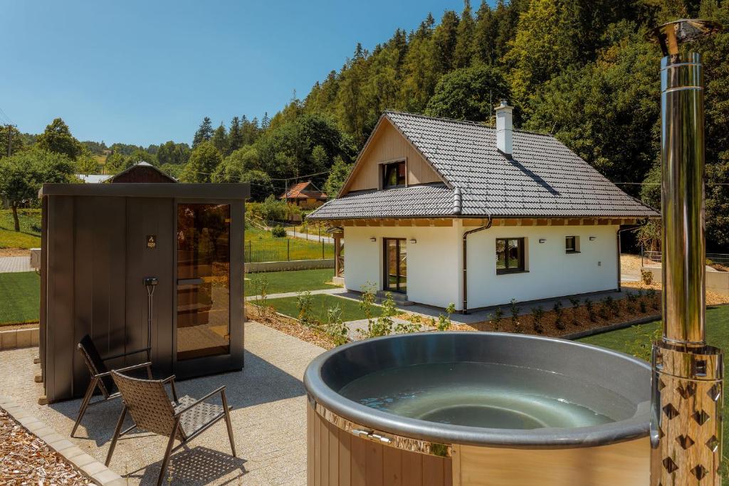 a hot tub in front of a house at BINDT chalets in Hnilčík