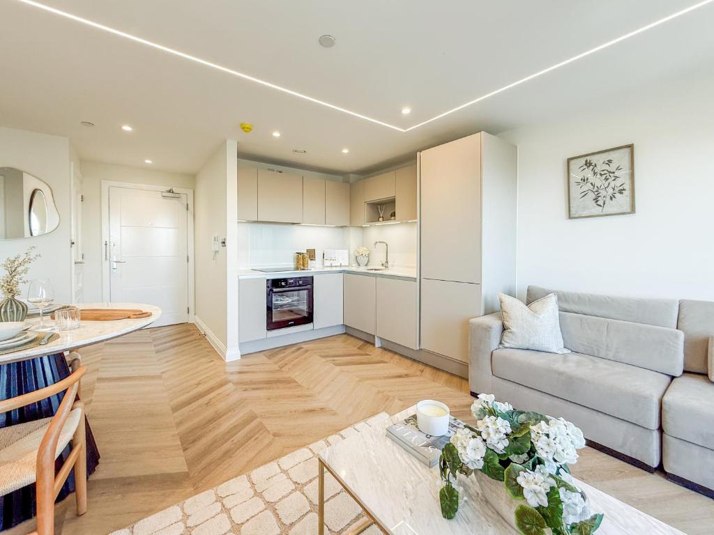 a living room with a couch and a table at Dorchester Centre Apartment - Free Parking & Views in Dorchester