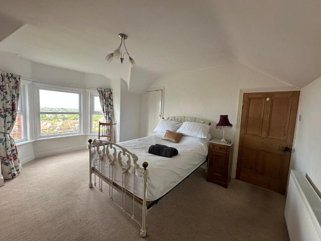 Ένα ή περισσότερα κρεβάτια σε δωμάτιο στο Sunset Cottage