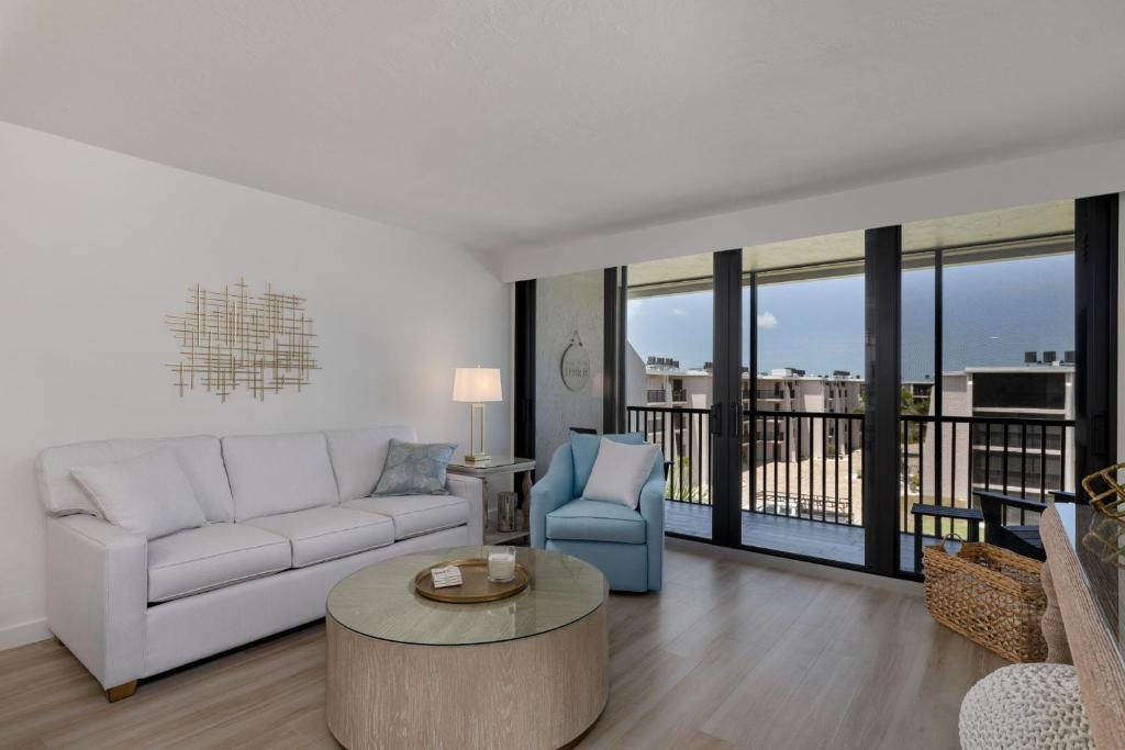 a living room with a couch and a table at Sundial F403 - Beach Bliss in Sanibel