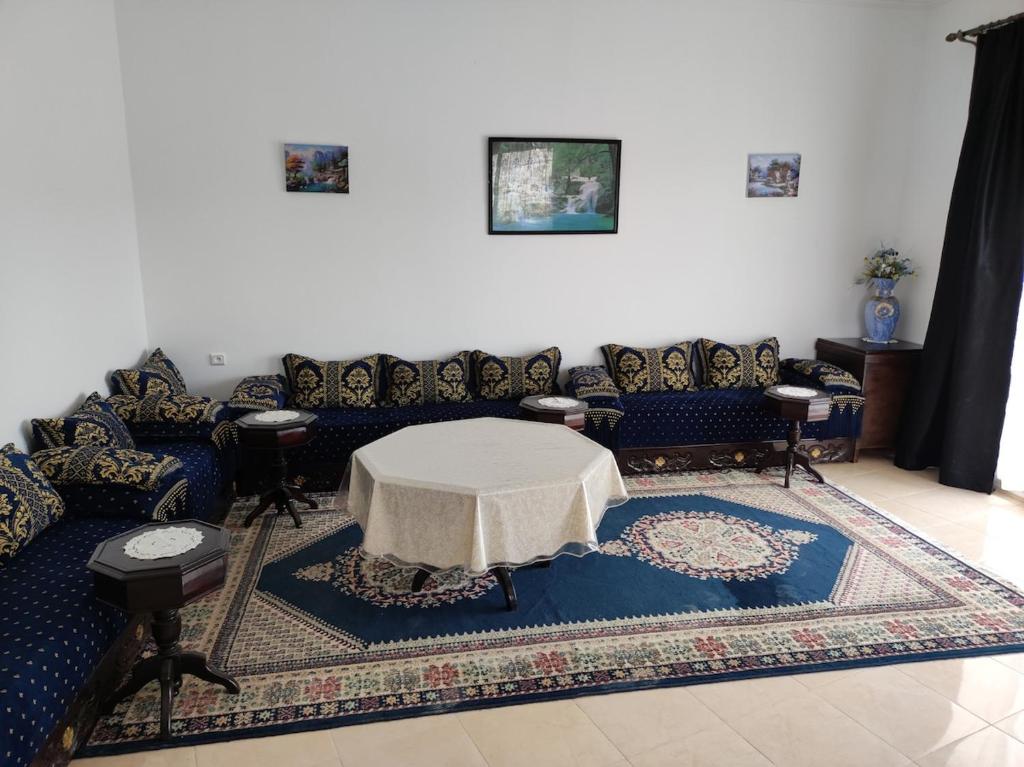 a living room with a couch and a table at Apartment in Villa - Tangier in Tangier