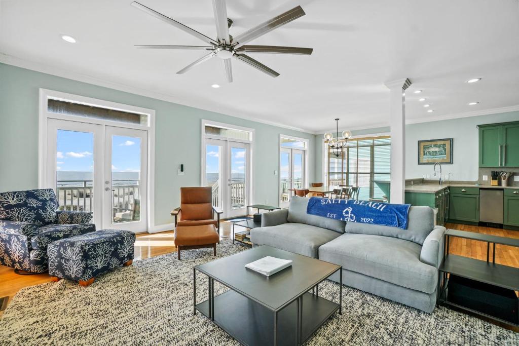 a living room with a couch and a table at Salty Beach by Coastline Vacation Rentals in Cape San Blas