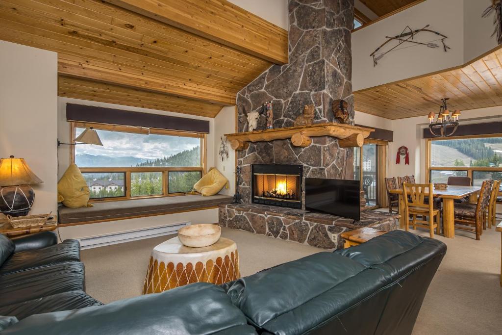a living room with a couch and a fireplace at Beaverhead Condo | 105 Beaverhead #301 in Big Sky