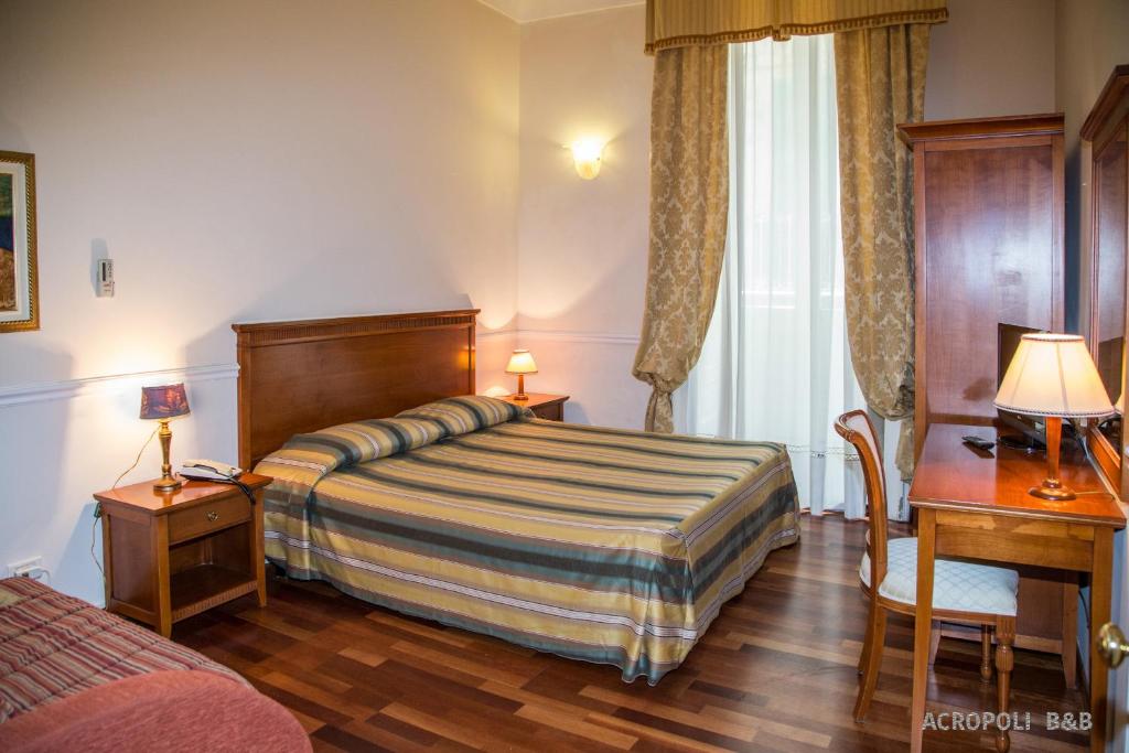 Un pat sau paturi într-o cameră la Residence Acropoli