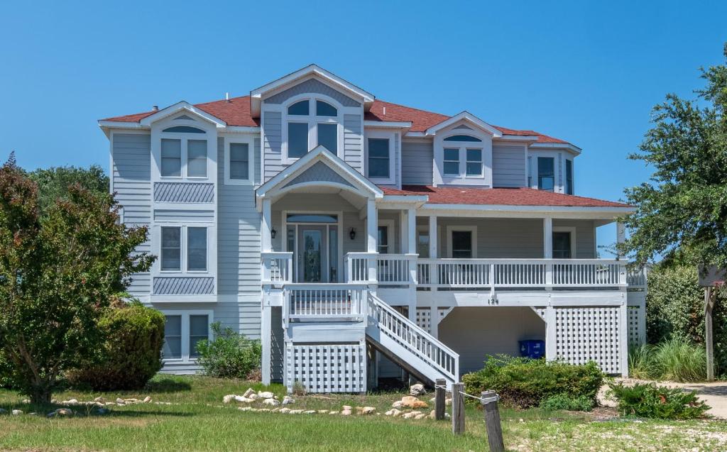 a large white house with a red roof at D3502 Sun King - Pool, Hot Tub, Pets OK, Oceanside in Duck