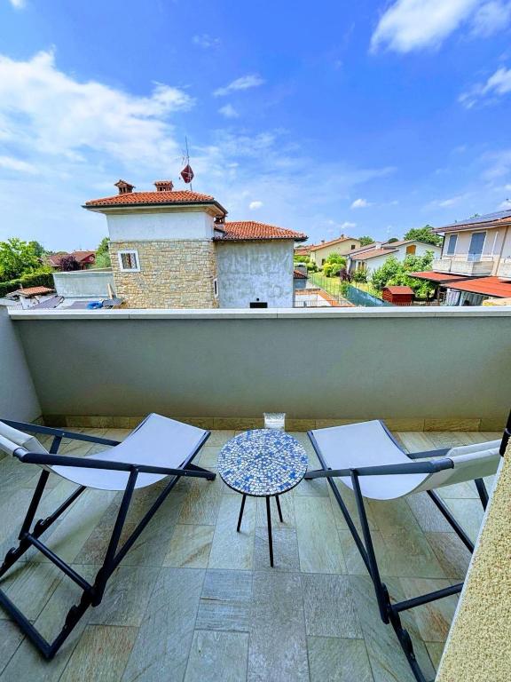 a patio with two chairs and a table on a balcony at Dany's Chill House in Paderno Franciacorta