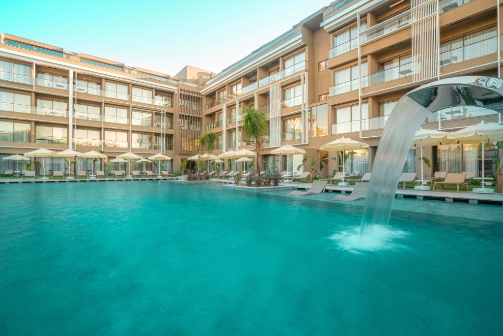 a swimming pool with a fountain in front of a building at Prive Side Suite & Spa Hotel - Adults Only 16 Plus in Side