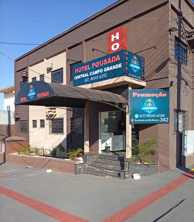 a building with a sign in front of it at Hotel Pousada Central Campo Grande in Campo Grande