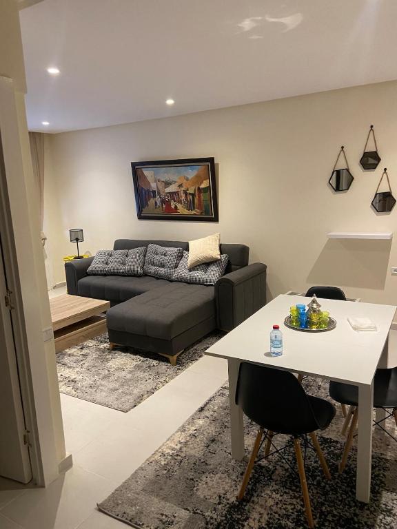 a living room with a couch and a table at Rabat Easy Access in Rabat