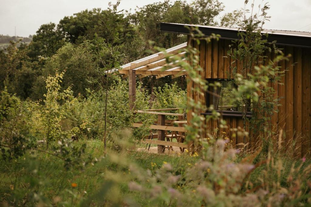 a wooden cabin in the middle of a field at Cuilcagh Cabins in Letterbreen