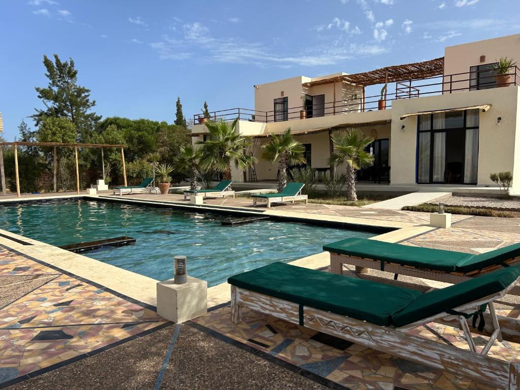 a house with a swimming pool in front of it at La Perle d'Argan in Essaouira