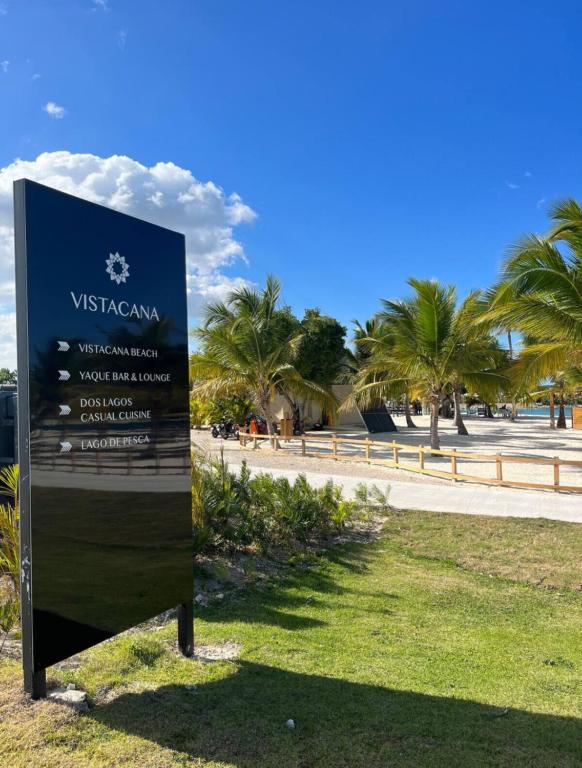 a sign in the grass next to a road at Villa Labuena in Punta Cana