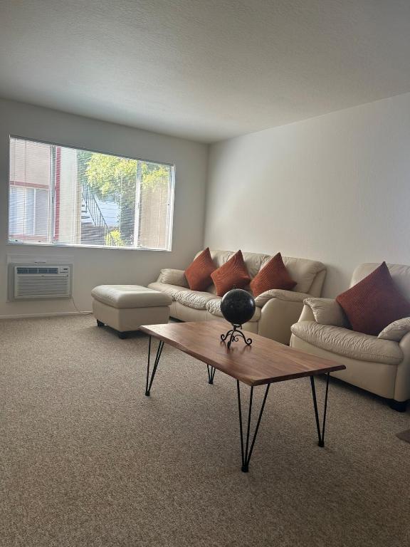 a living room with a couch and a coffee table at Home away from home in Concord
