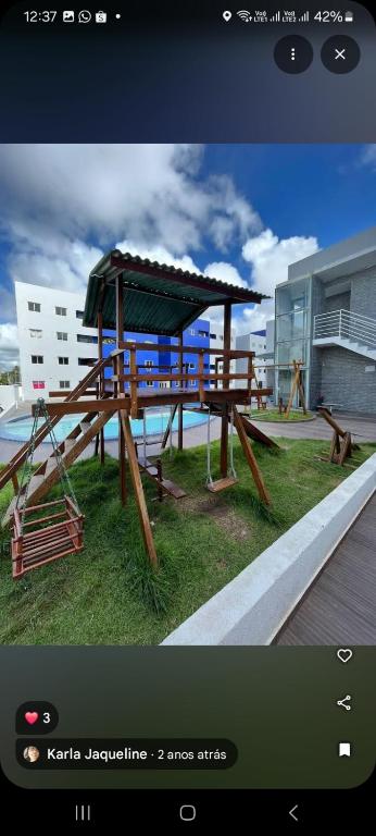 a picture of a picnic table with a playground at Impérium residence clube in João Pessoa
