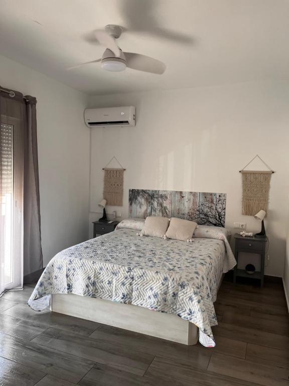 a bedroom with a bed and a ceiling fan at Horrillo San José in San José