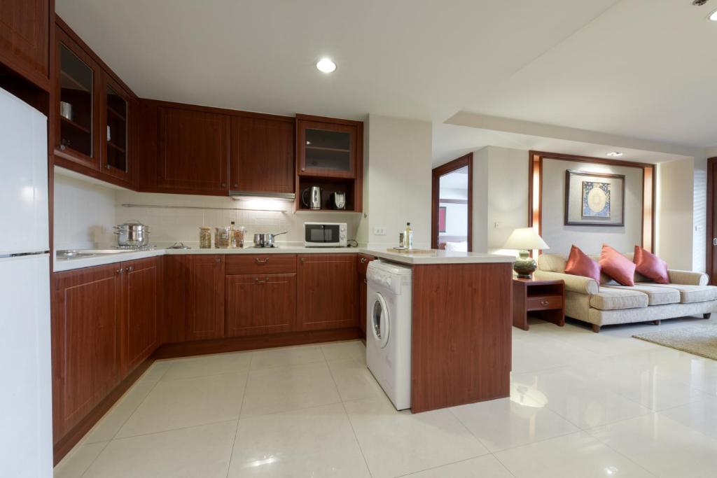 An open-plan kitchenette leading into a furnished sitting area.