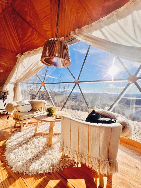 a room with a large window in a tent at Bóreas Ecoluxury Glamping in El Calafate