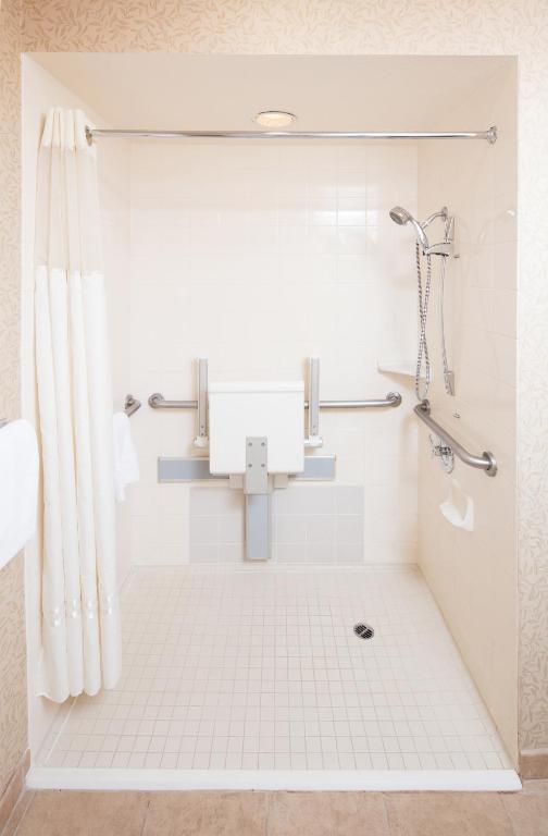 a white bathroom with a shower and a sink at Red Lion Hotel Pendleton in Pendleton