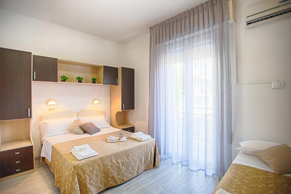 Postel nebo postele na pokoji v ubytování B&B Hotel Serenità