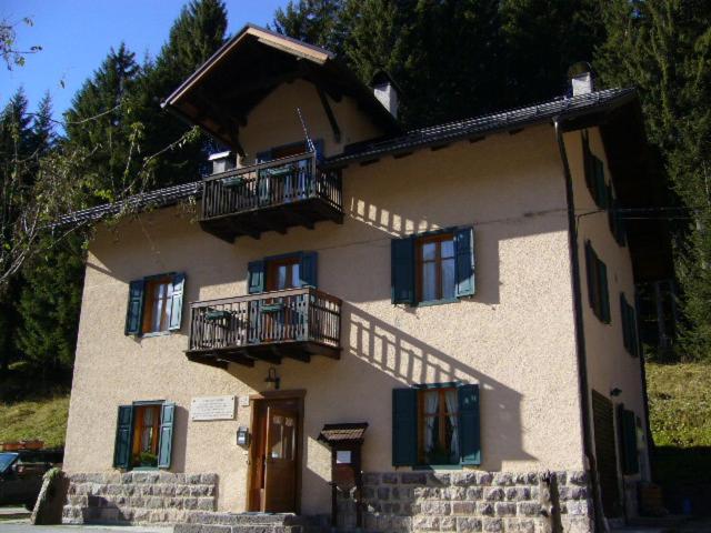 a large house with two balconies on top of it at Ostello SanMartino in San Martino di Castrozza