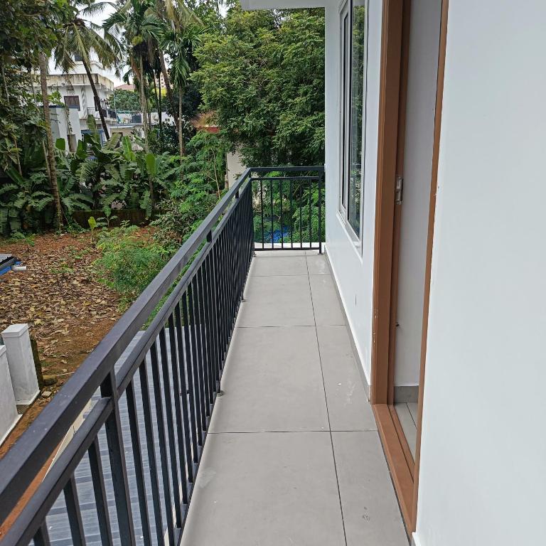 a balcony of a house with a walkway at Hotel Eleven Space Kochi in Cochin